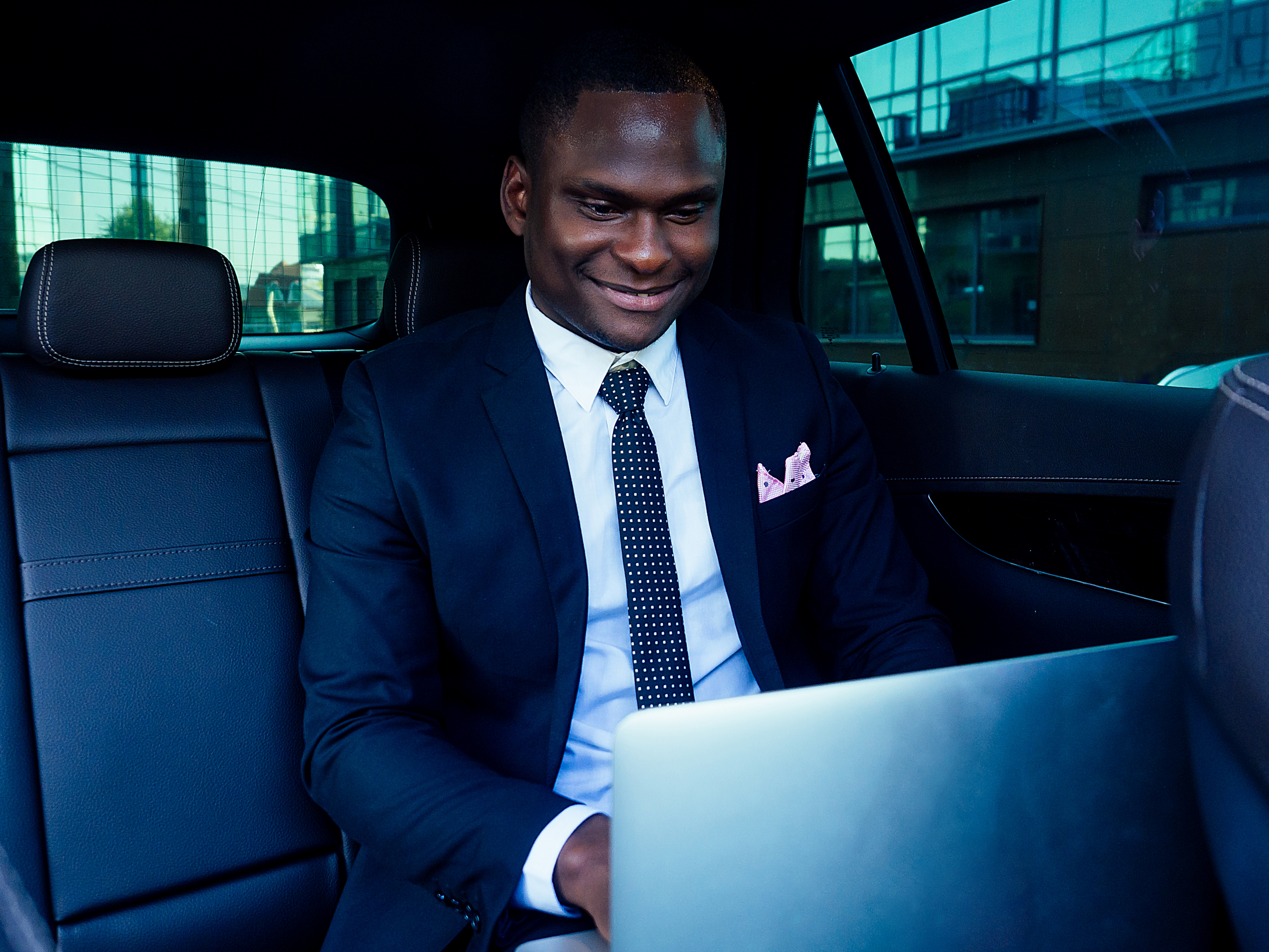 Business professional working on a laptop while traveling