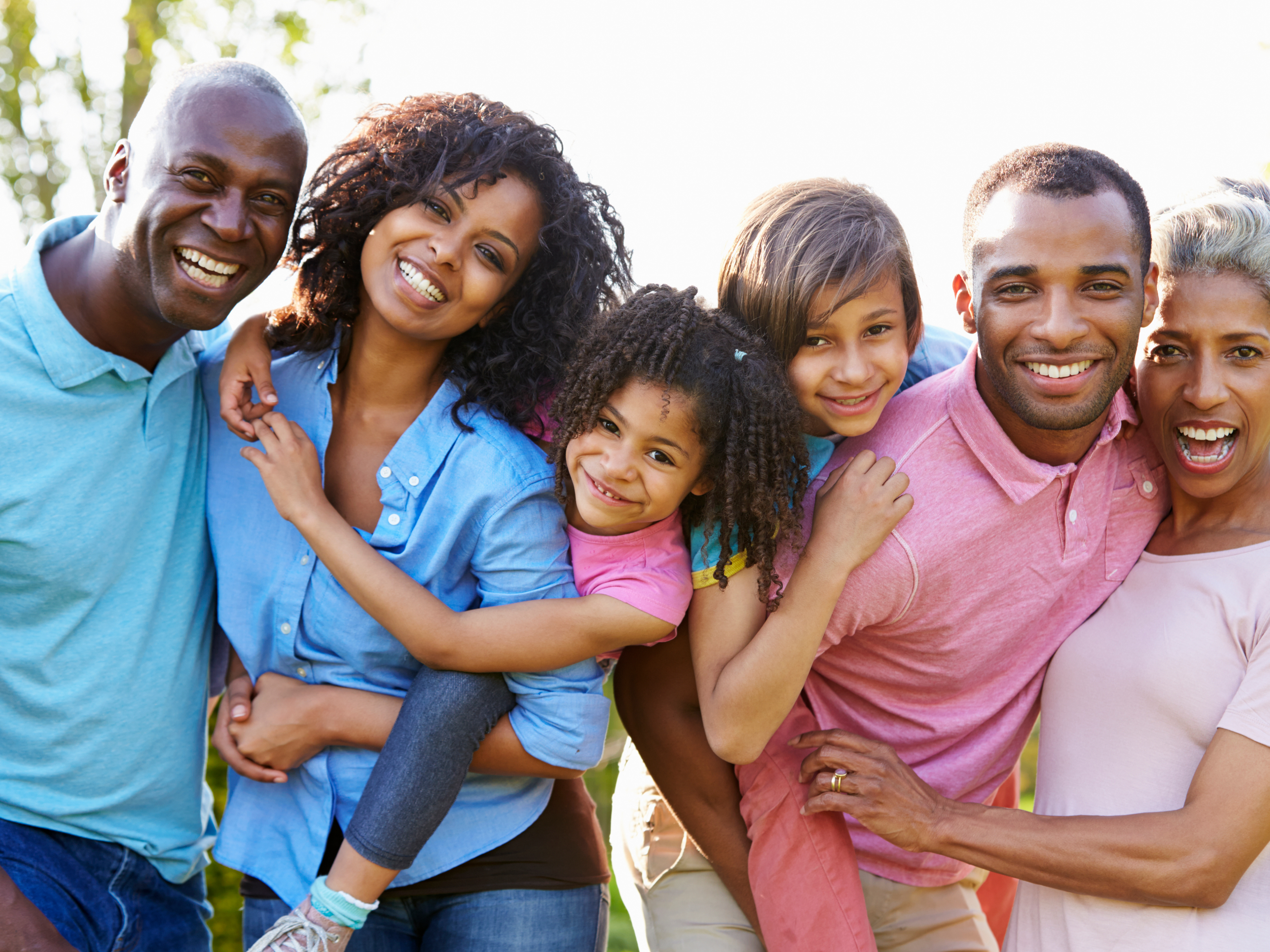 Multi-generational Black family smiling together outdoors