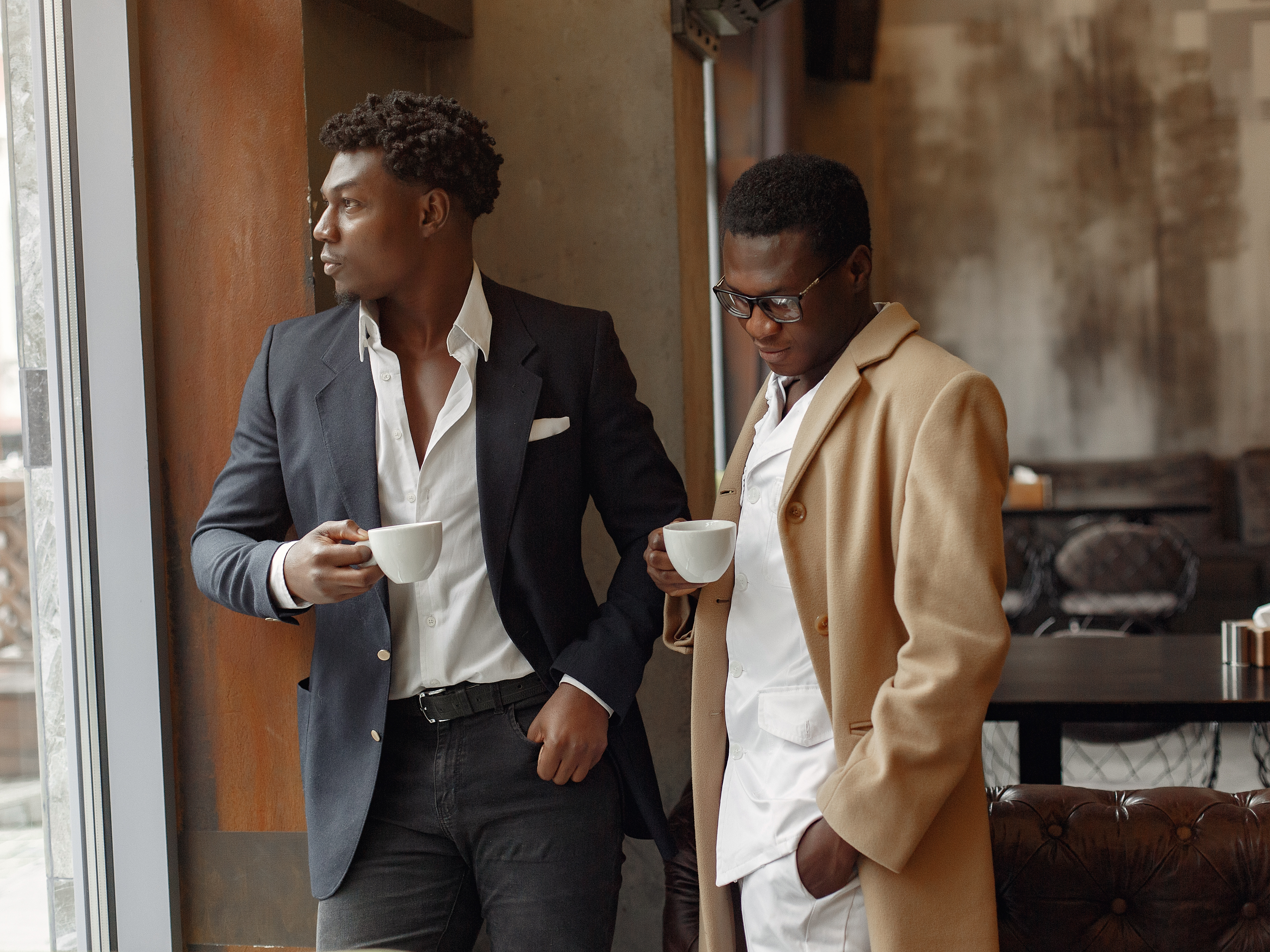 Two young Black entrepreneurs in a modern lounge setting